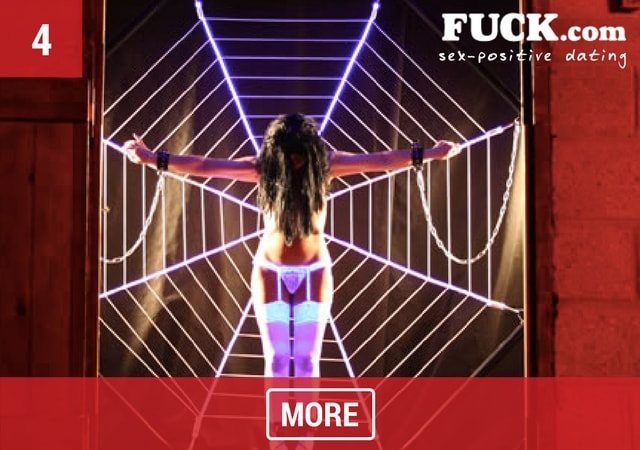 Sexy woman in lingerie on a spider web fetish equipment. Popcorn.dating