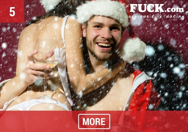 Sexy couple hugging in Santa Claus outfits with champagne