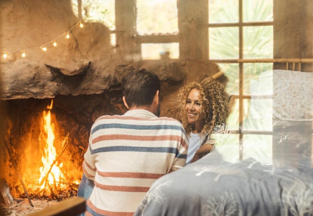 couple having a cozy winter date infront of a fireplace